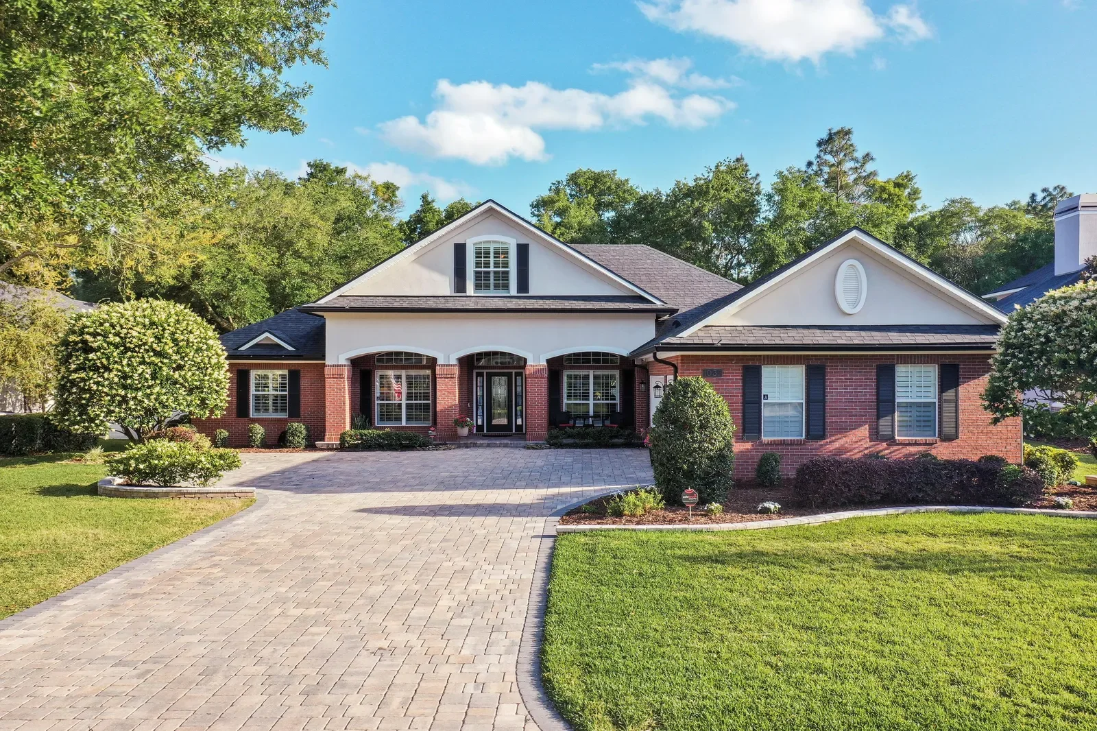 Brick home with paver drive and manicured lawn in St. Johns, FL. Real estate photography by Megapixeler