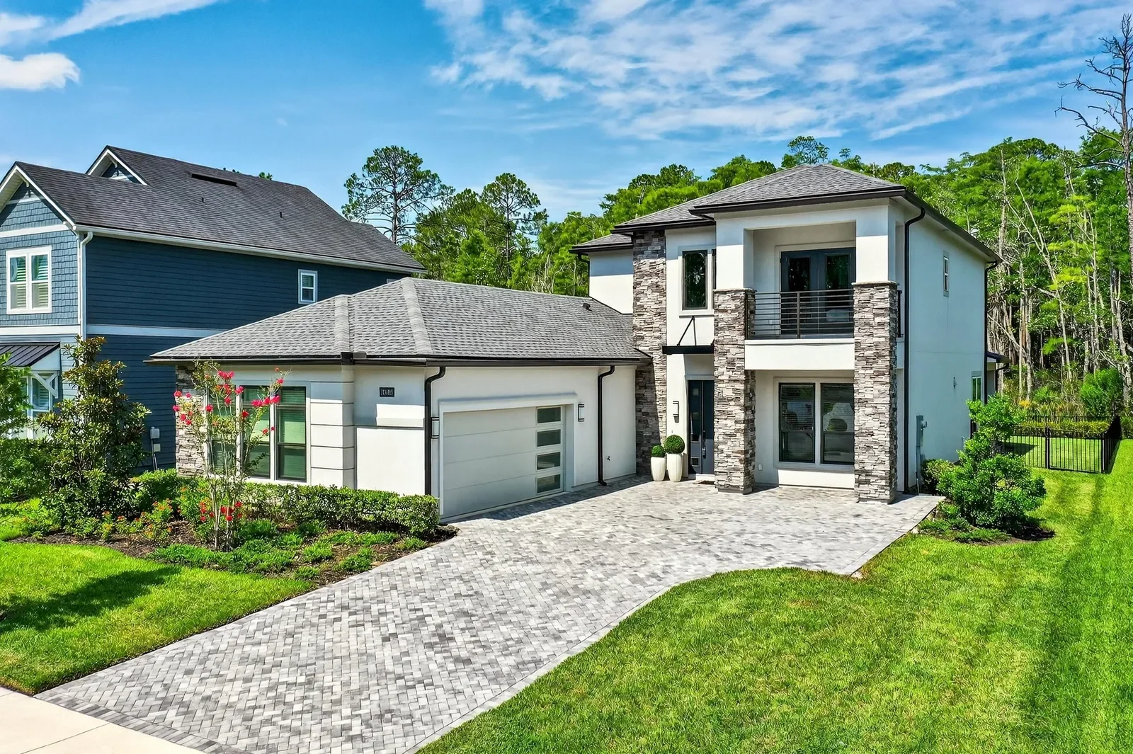 Contemporary two-story home with stone accents in Jacksonville, FL. Real estate photography by Megapixeler