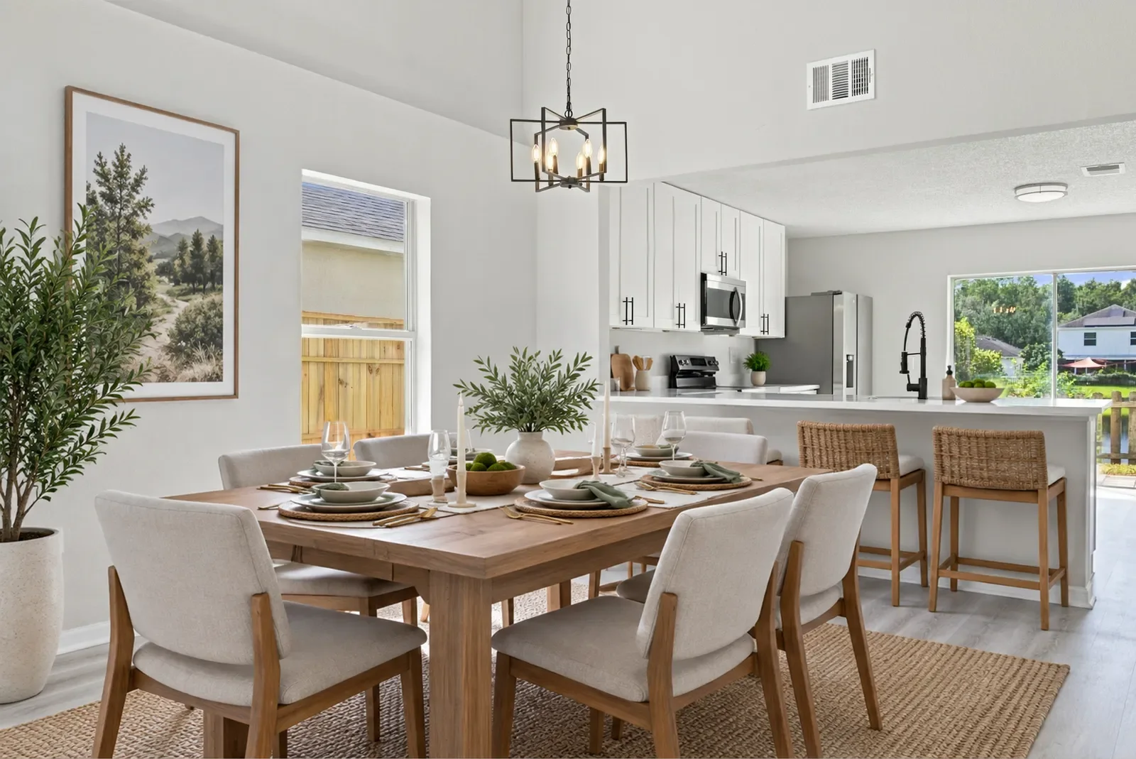 Dining room staged with a farmhouse table and woven rug in Jacksonville, FL. Virtual staging by Megapixeler