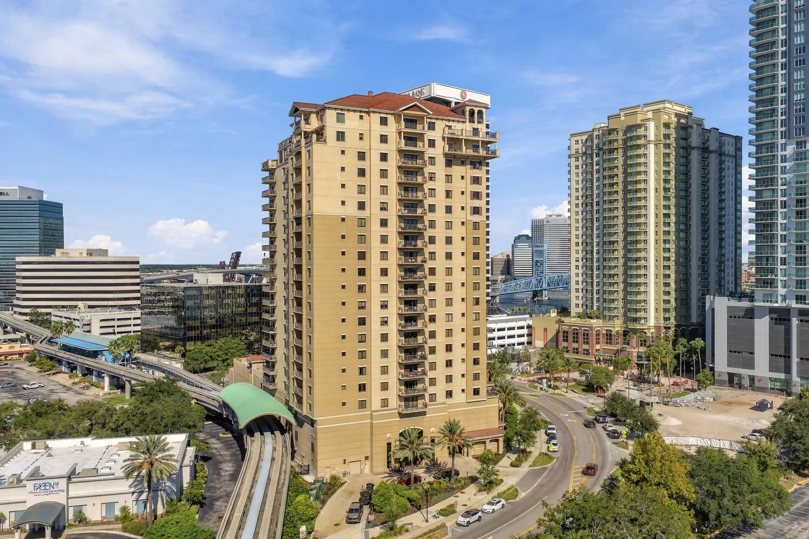 Drone photo of a Southbank condominium tower with the downtown skyline and Main Street Bridge in Jacksonville, FL. Drone photography by Megapixeler