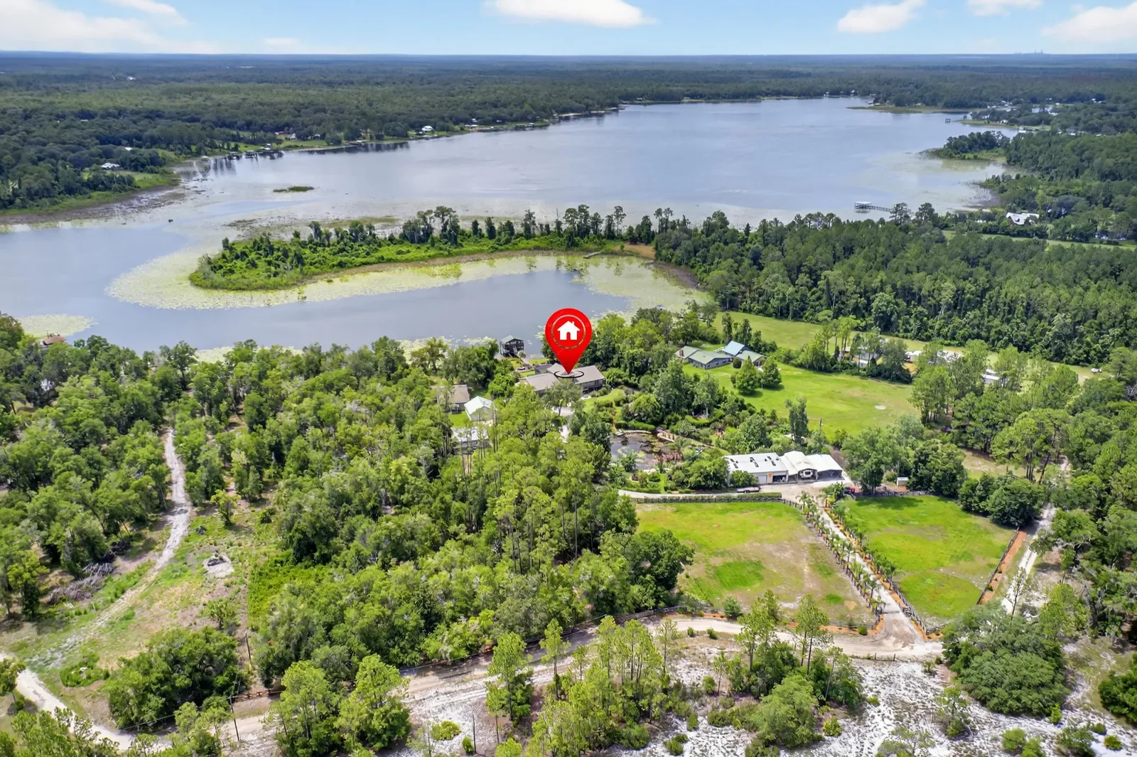 Drone photo with location pin over a lakefront estate in Pomona Park, FL. Drone photography by Megapixeler