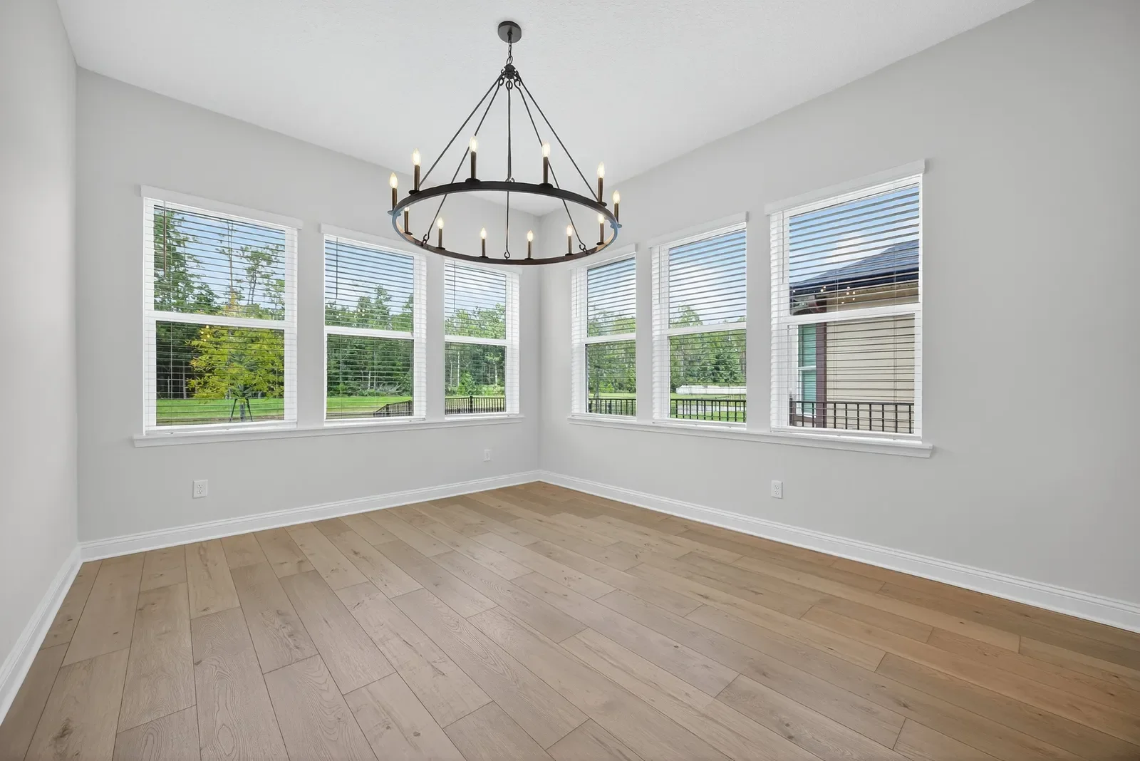 Empty dining room with chandelier before virtual staging in North Florida. Real estate photography by Megapixeler