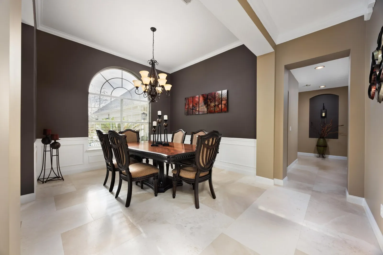Formal dining room with chandelier in Jacksonville, FL. Real estate photography by Megapixeler