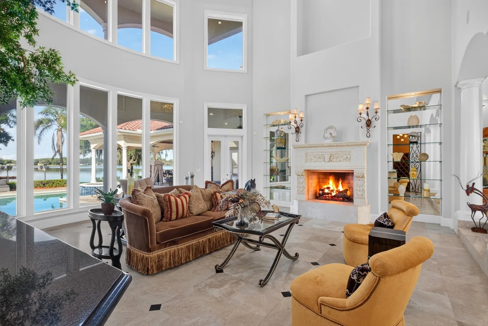 Formal family room with fireplace and river and pool views in Jacksonville, FL. Real estate photography by Megapixeler