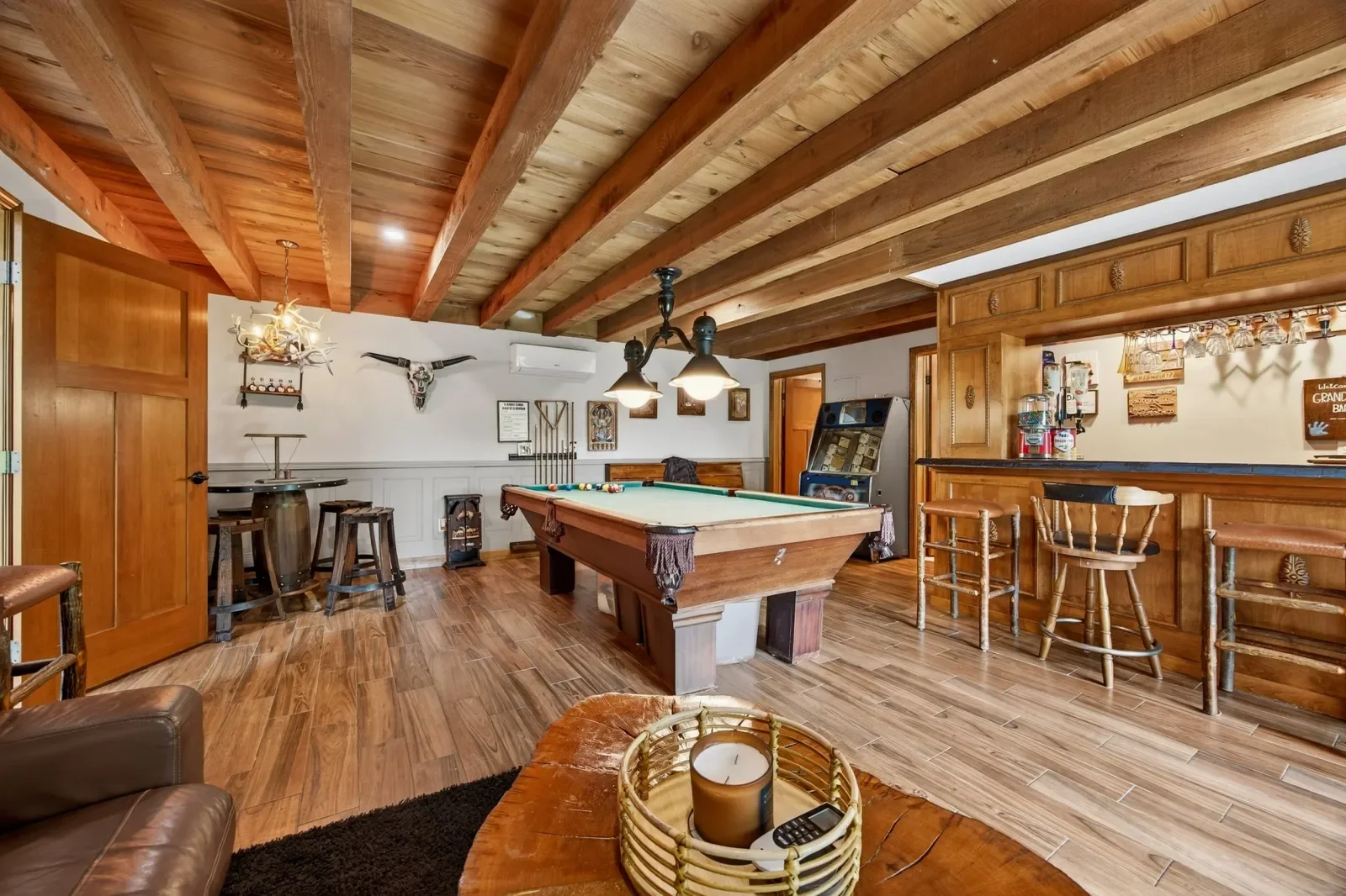 Game room with billiards and a wood-paneled bar in Pomona Park, FL. Real estate photography by Megapixeler