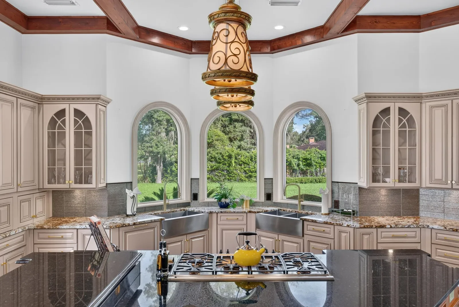 Gourmet estate kitchen with arched windows in Jacksonville, FL. Real estate photography by Megapixeler