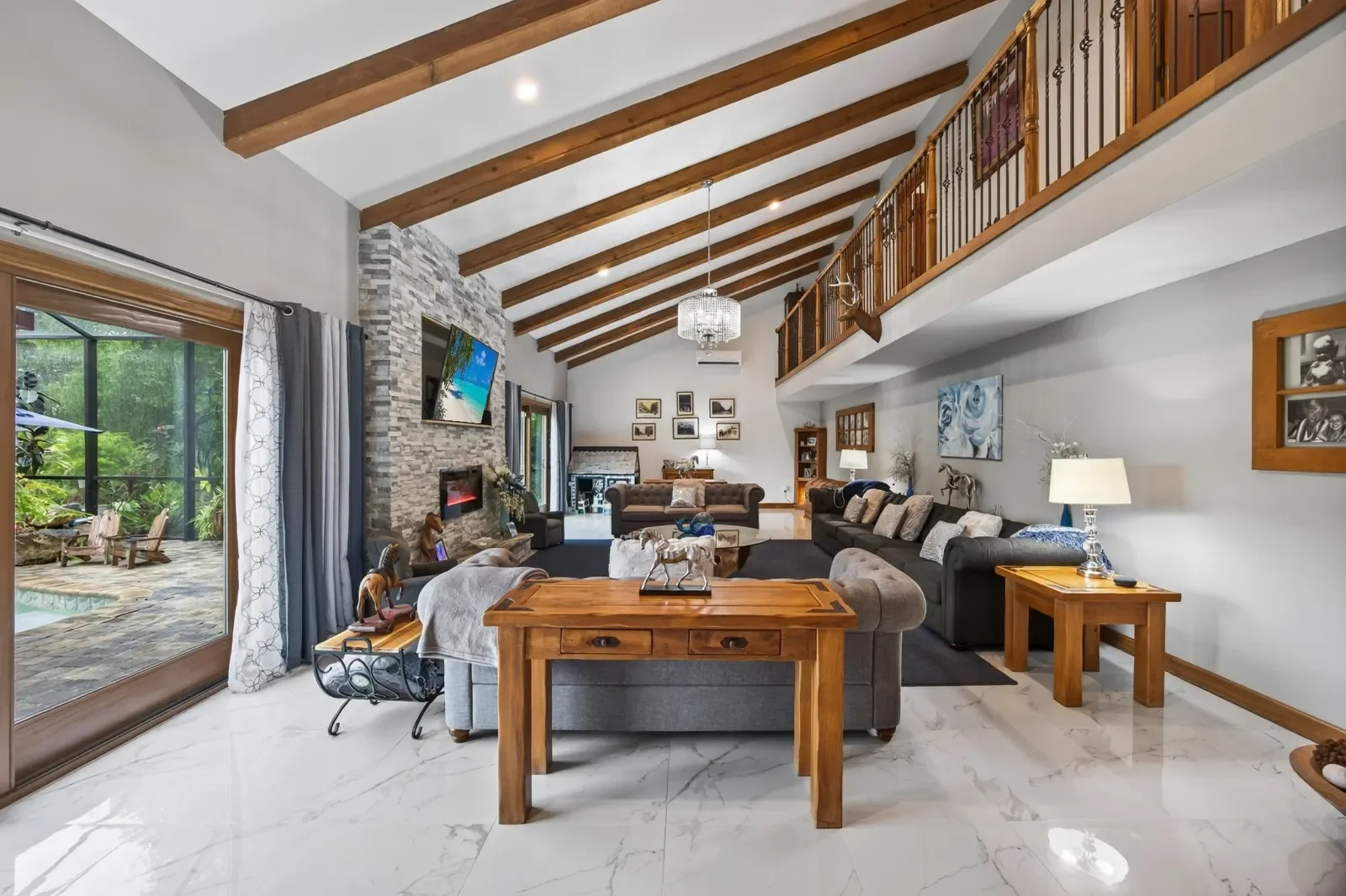 Great room with beamed ceiling and lake views in Pomona Park, FL. Real estate photography by Megapixeler