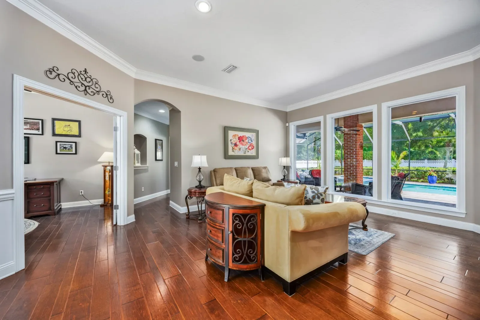Living room with an angled view to the pool in North Florida. Real estate photography by Megapixeler