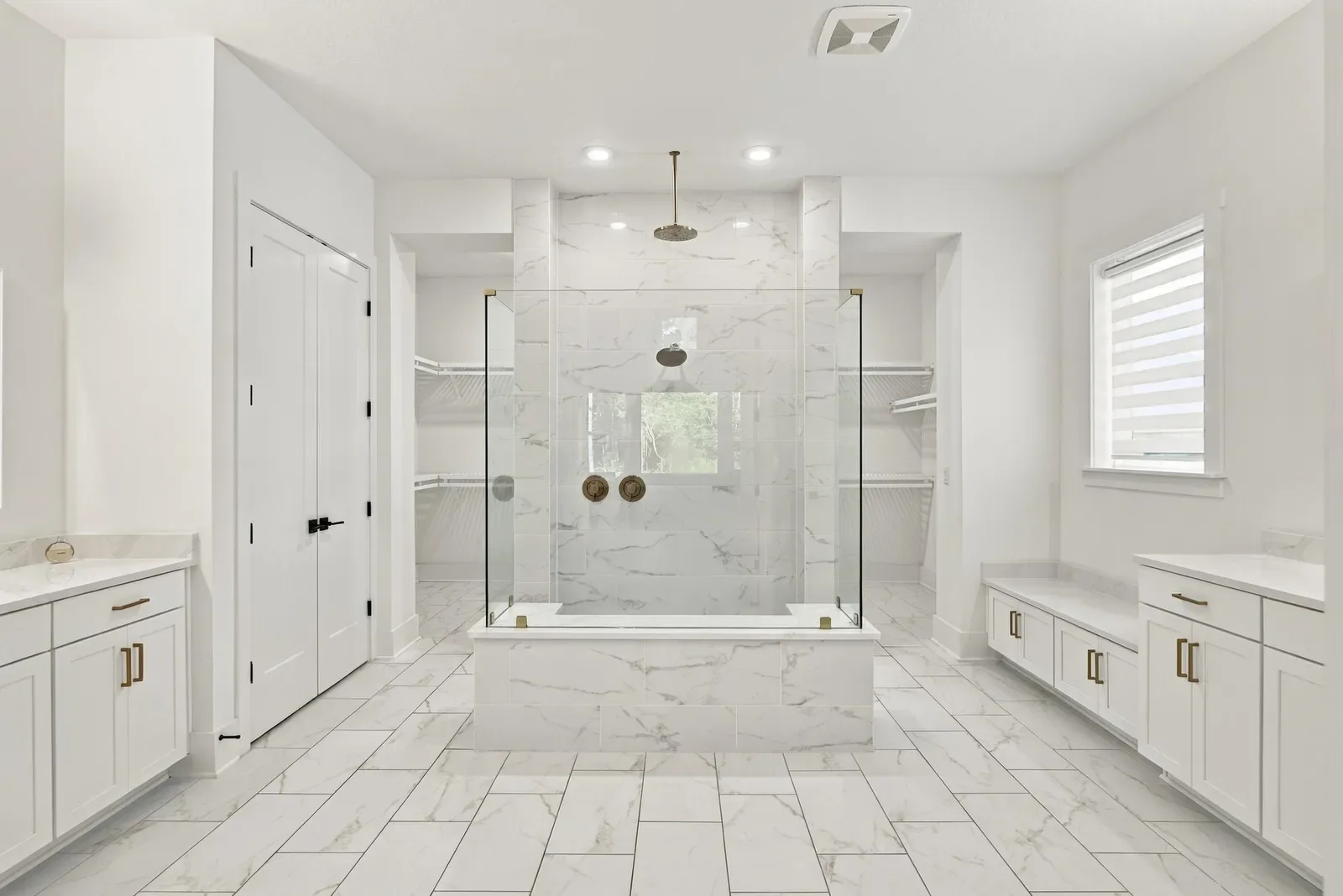 Marble primary bath with glass walk-in shower in Ponte Vedra Beach, FL. Real estate photography by Megapixeler