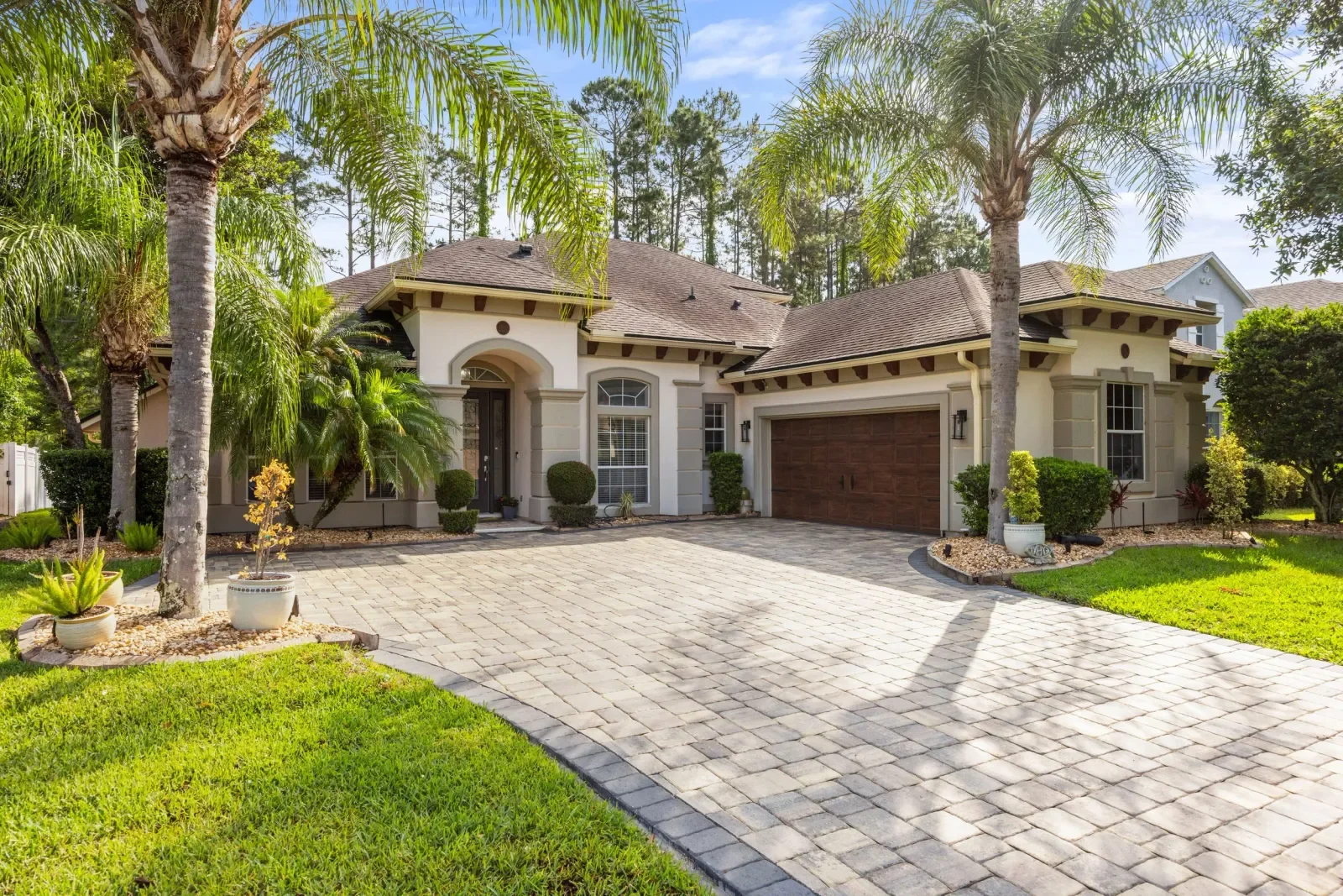 Mediterranean home with courtyard entry and paver drive in North Florida. Real estate photography by Megapixeler
