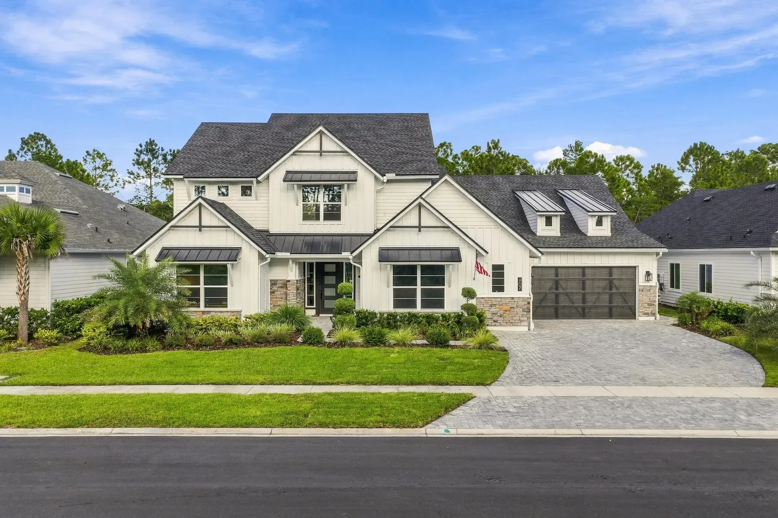 Modern farmhouse front elevation in daylight in Ponte Vedra Beach, FL. Real estate photography by Megapixeler