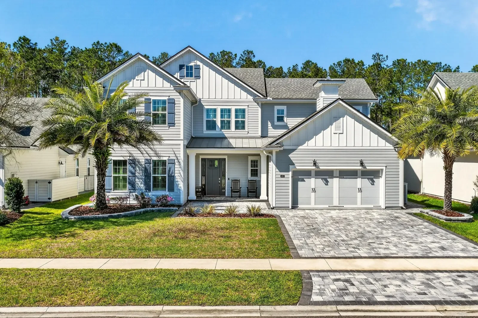 Modern farmhouse front elevation with paver drive in St. Johns, FL. Real estate photography by Megapixeler