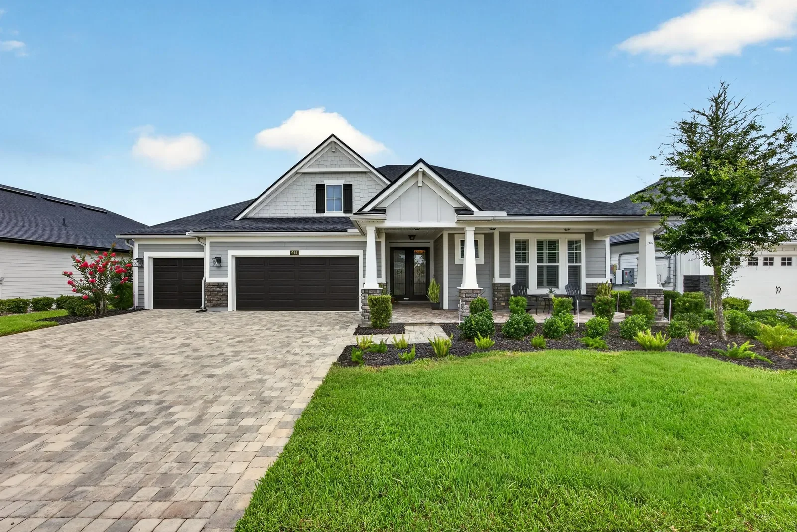 Modern farmhouse front with three-car garage in Middleburg, FL. Real estate photography by Megapixeler
