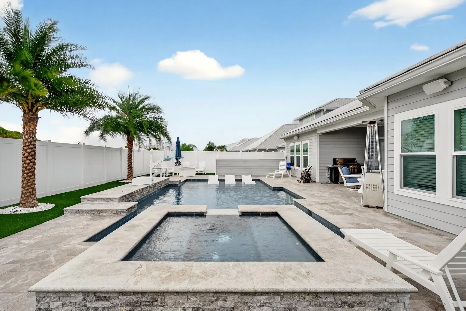 Modern pool and spa with sun shelf in St. Johns, FL. Real estate photography by Megapixeler