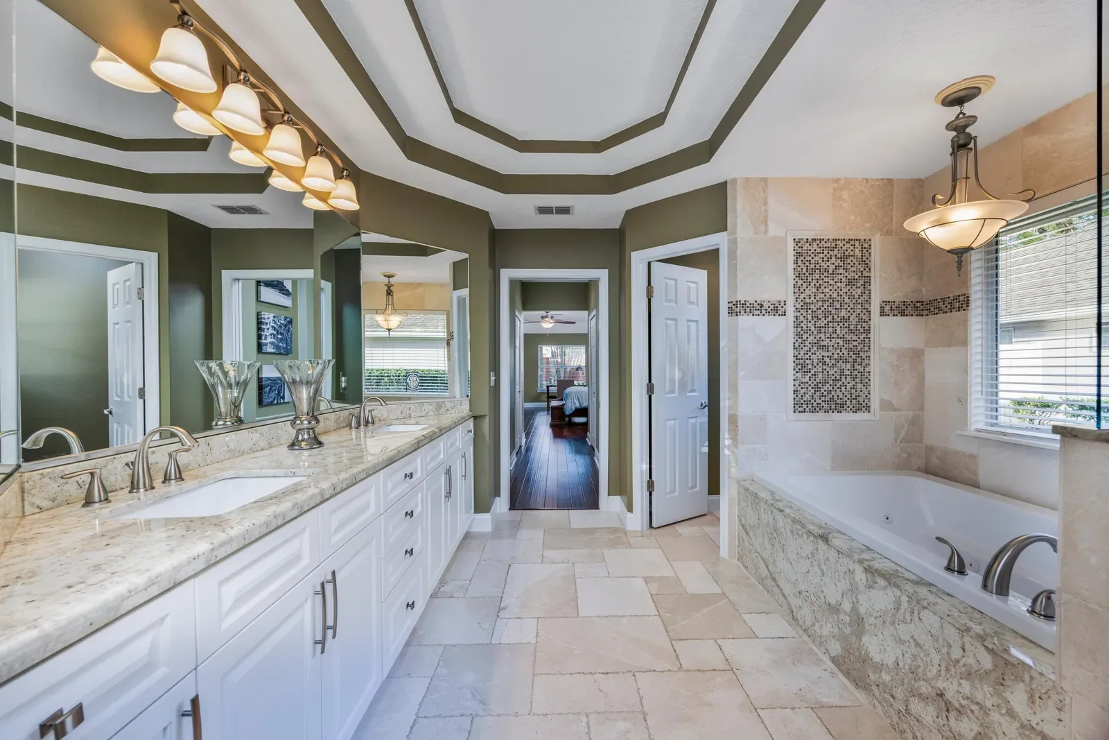 Primary bathroom with soaking tub and double vanity in Jacksonville, FL. Real estate photography by Megapixeler