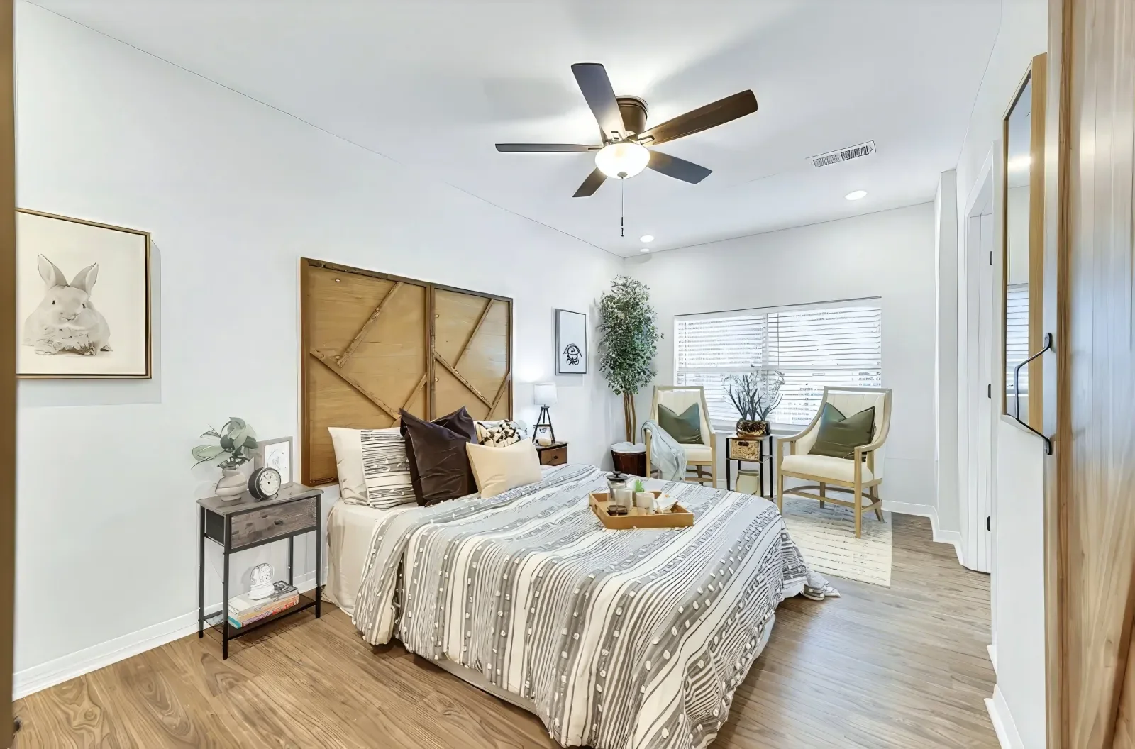 Primary bedroom with paneled accent wall in North Florida. Real estate photography by Megapixeler