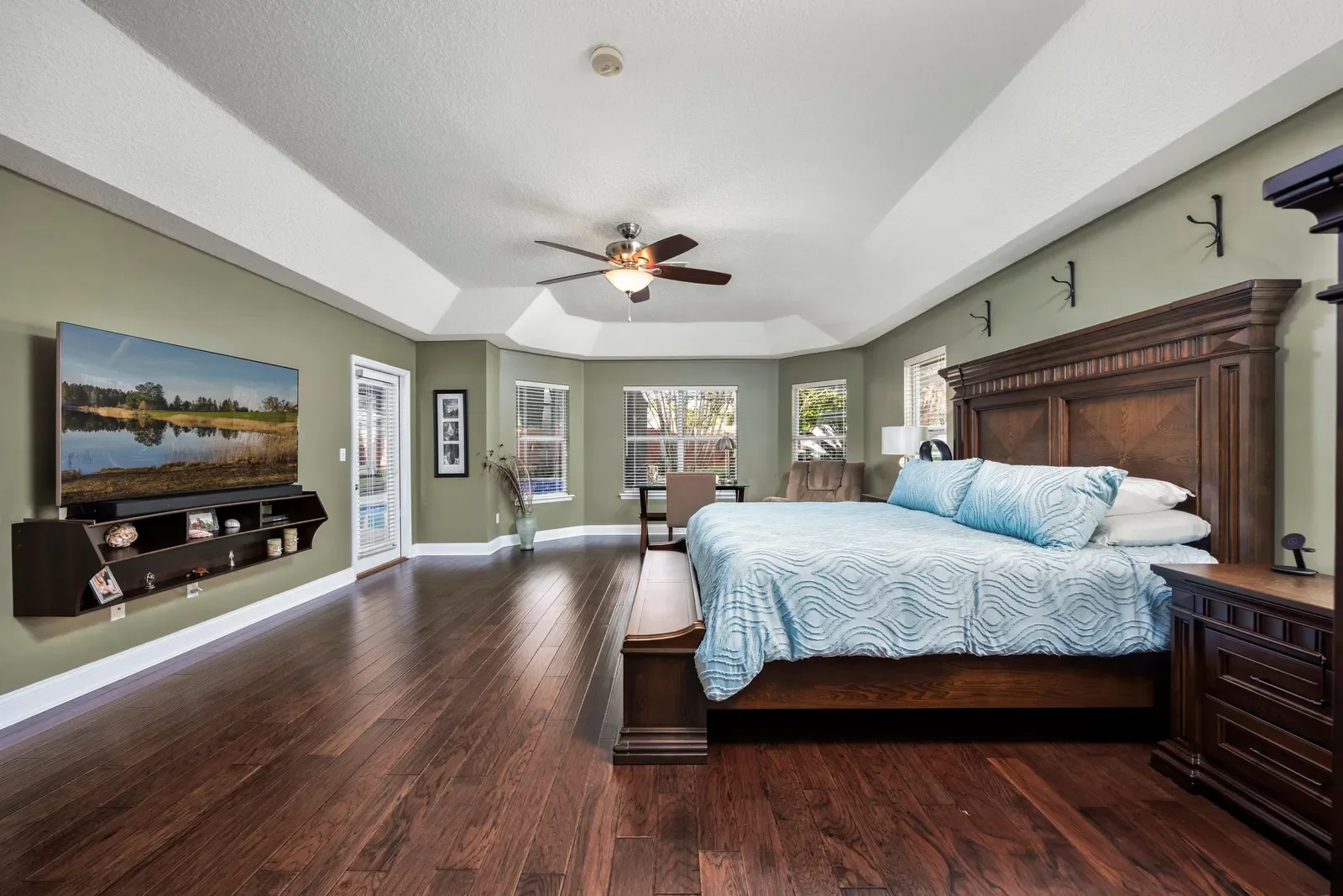 Primary bedroom with tray ceiling in Jacksonville, FL. Real estate photography by Megapixeler