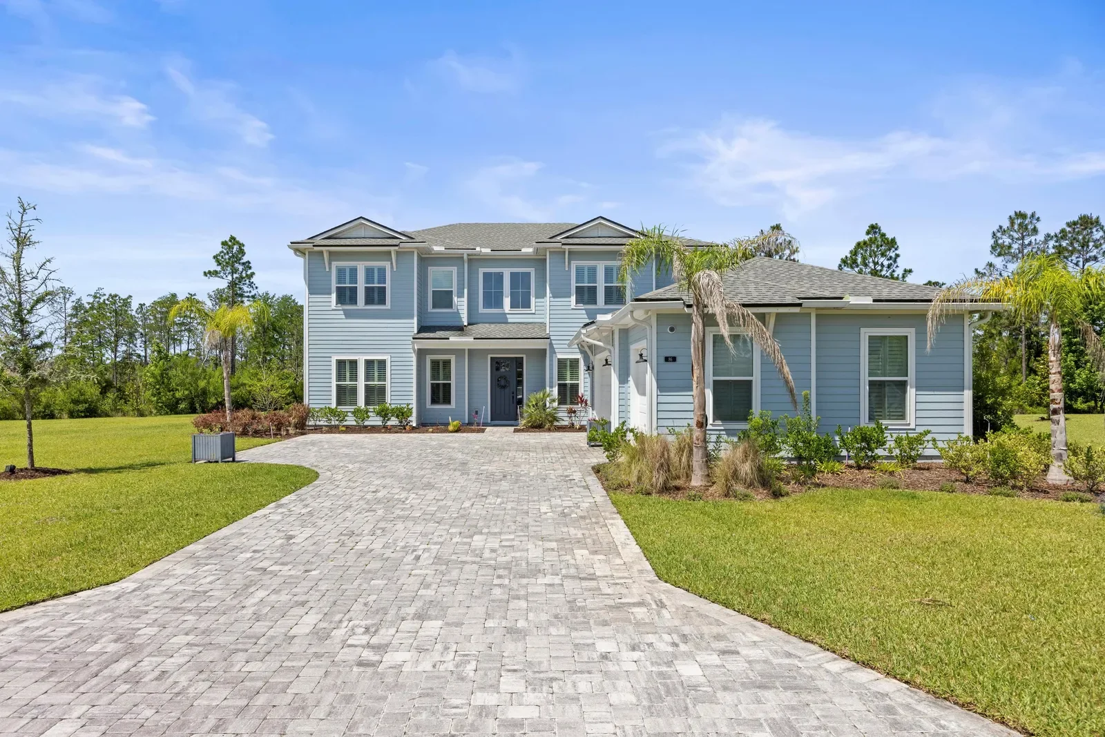 Two-story coastal home with paver drive in St. Johns, FL. Real estate photography by Megapixeler