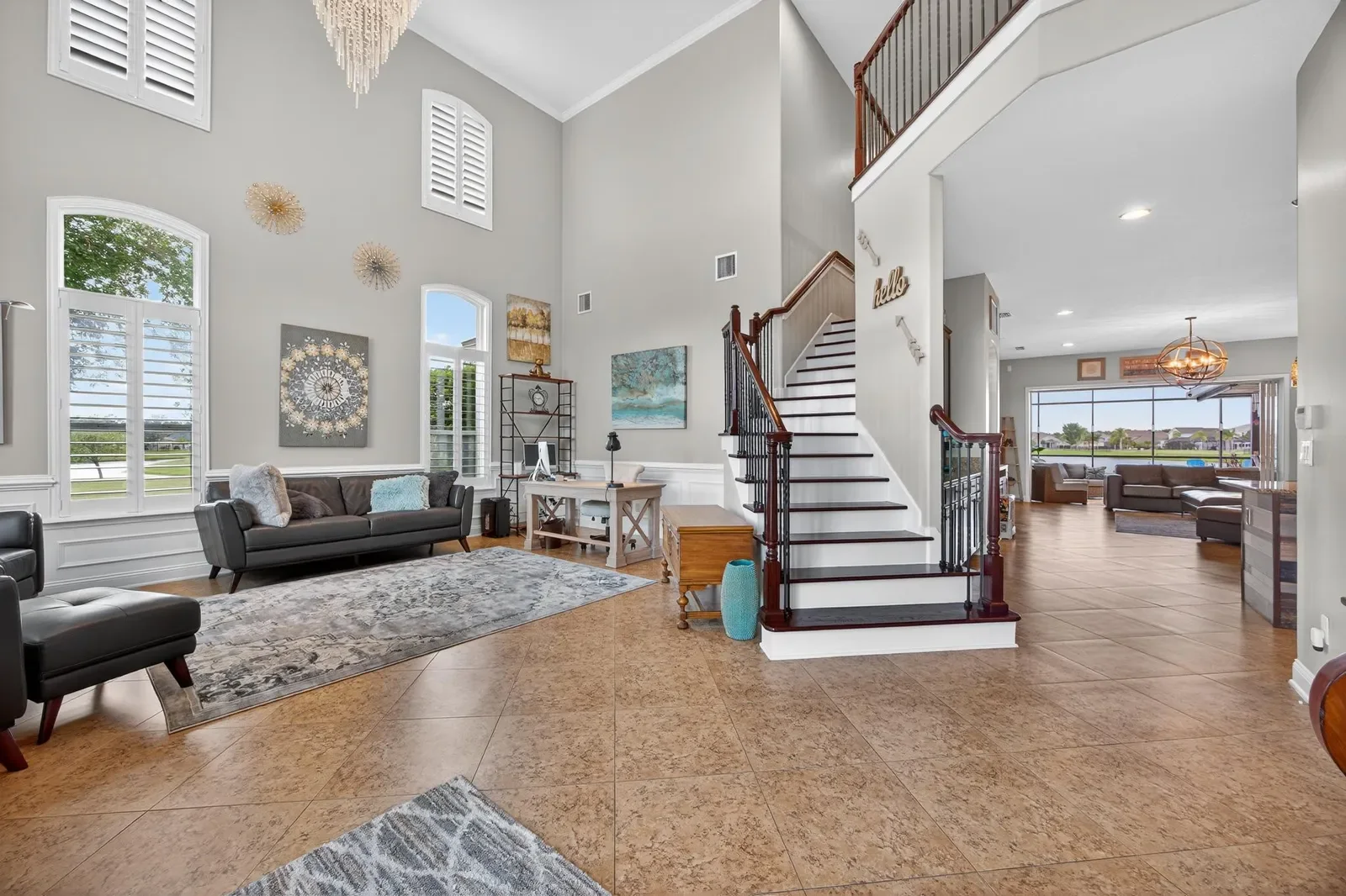 Two-story great room with staircase and lake views in St. Augustine, FL. Real estate photography by Megapixeler