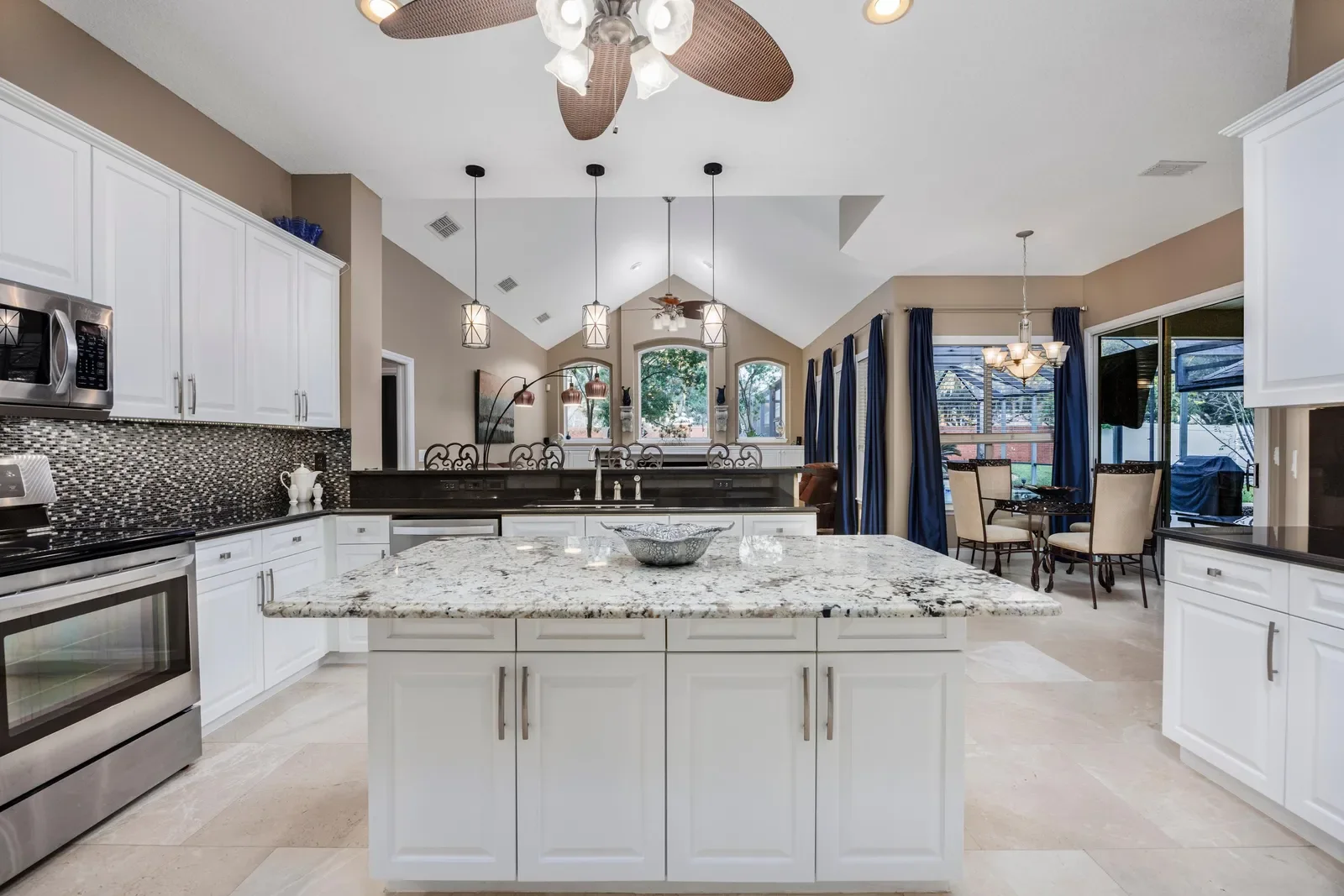 White kitchen with granite island in Jacksonville, FL. Real estate photography by Megapixeler
