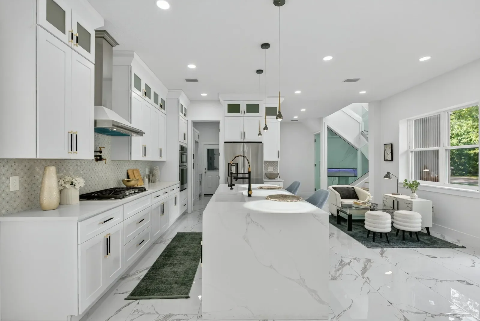 White kitchen with marble waterfall island in North Florida. Real estate photography by Megapixeler